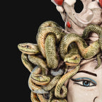 Handcrafted Teste di Moro with intricate green snakes and vibrant blue eyes, blending tradition and modern design.