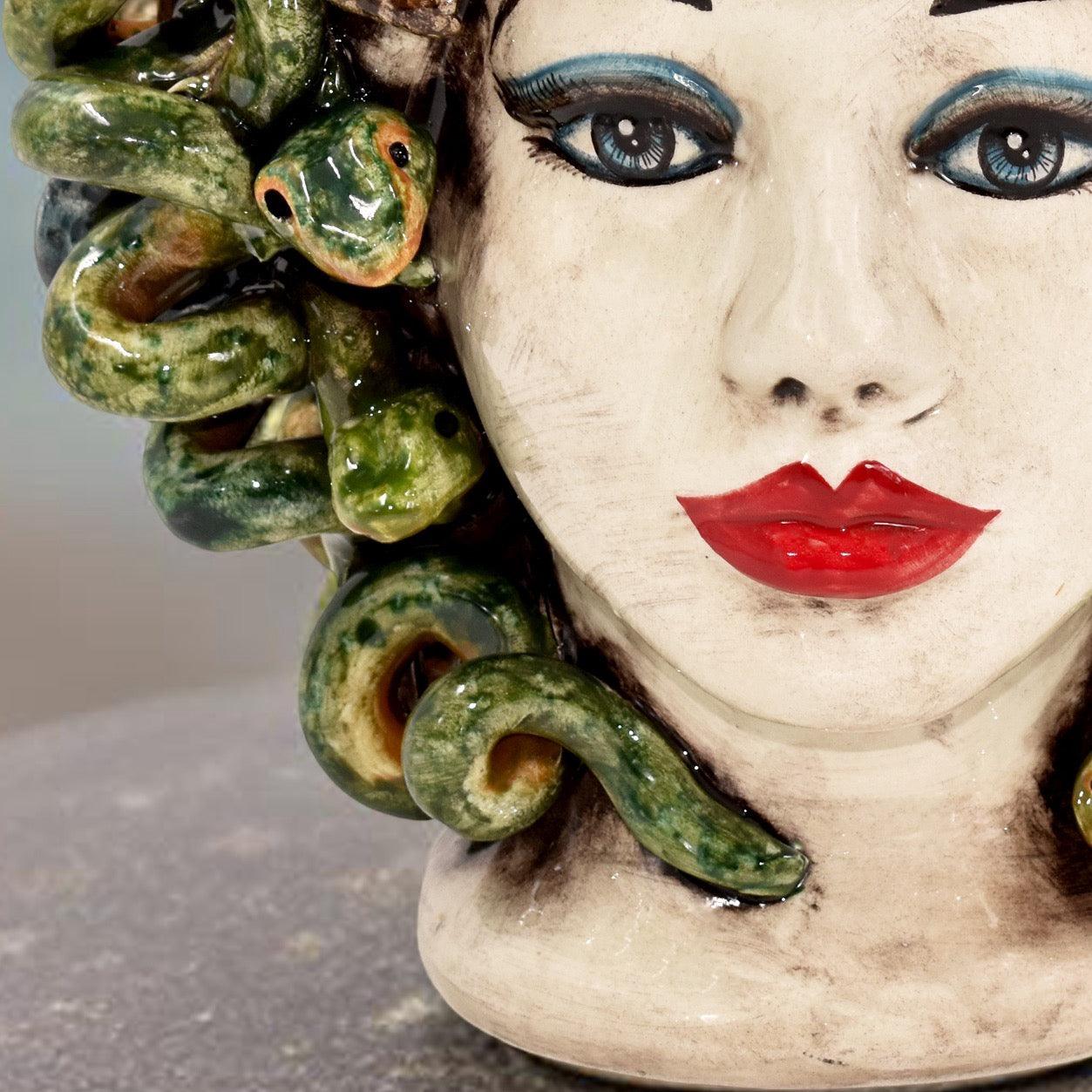 Handcrafted Teste di Moro ceramic with green snake hair, bold red lips, and striking blue eyes