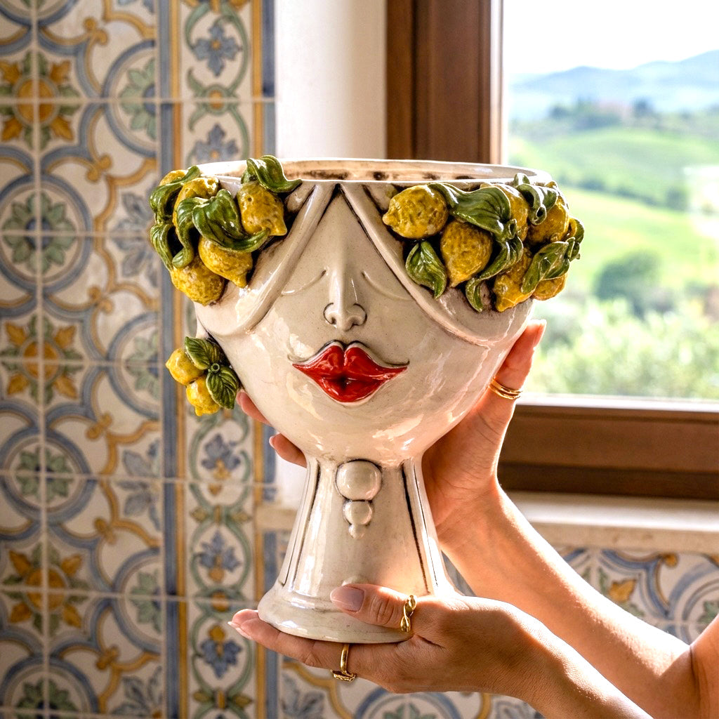 Handmade ceramic Teste di Moro planter with lemon garland, red lips, and traditional Sicilian tile background