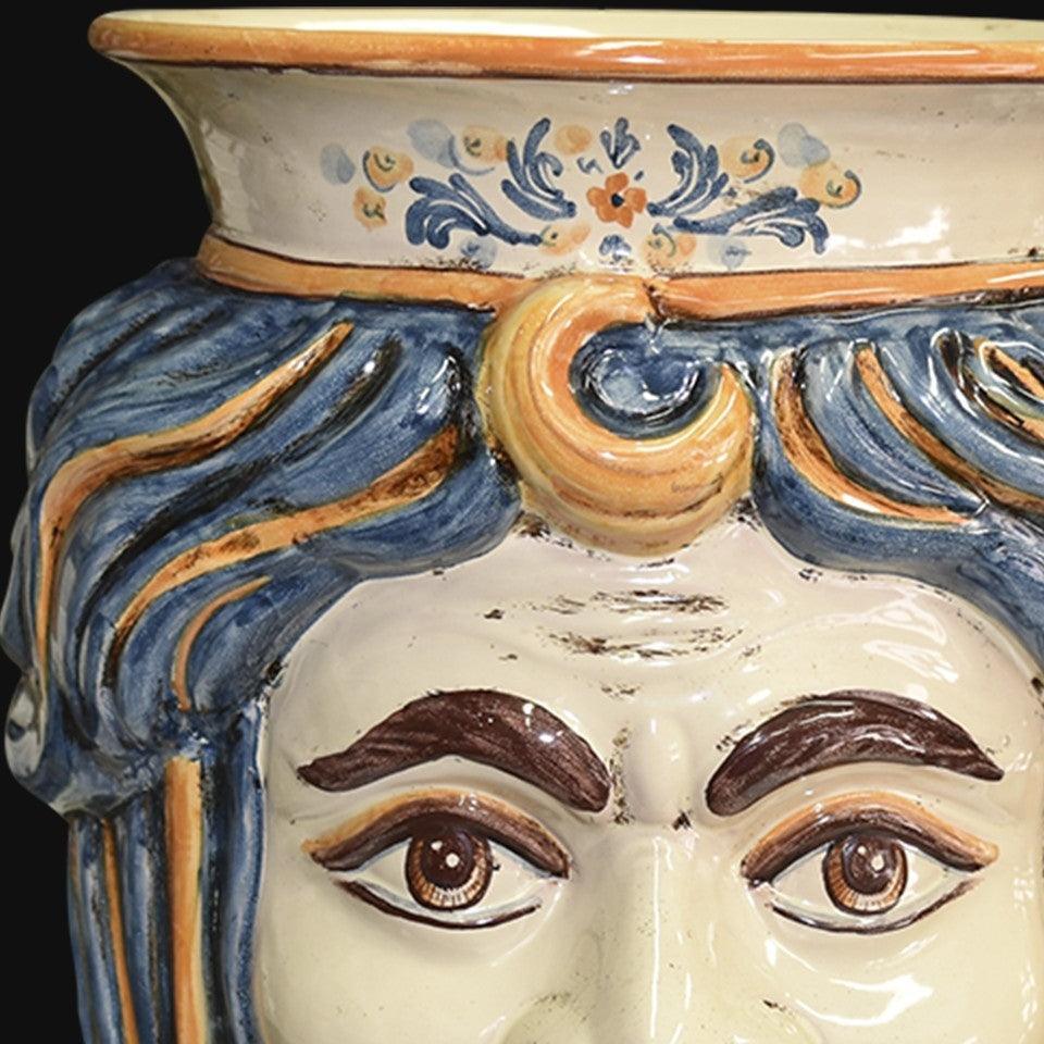Handcrafted Teste di Moro ceramic vase with blue and gold hair, detailed eyes, and floral motifs