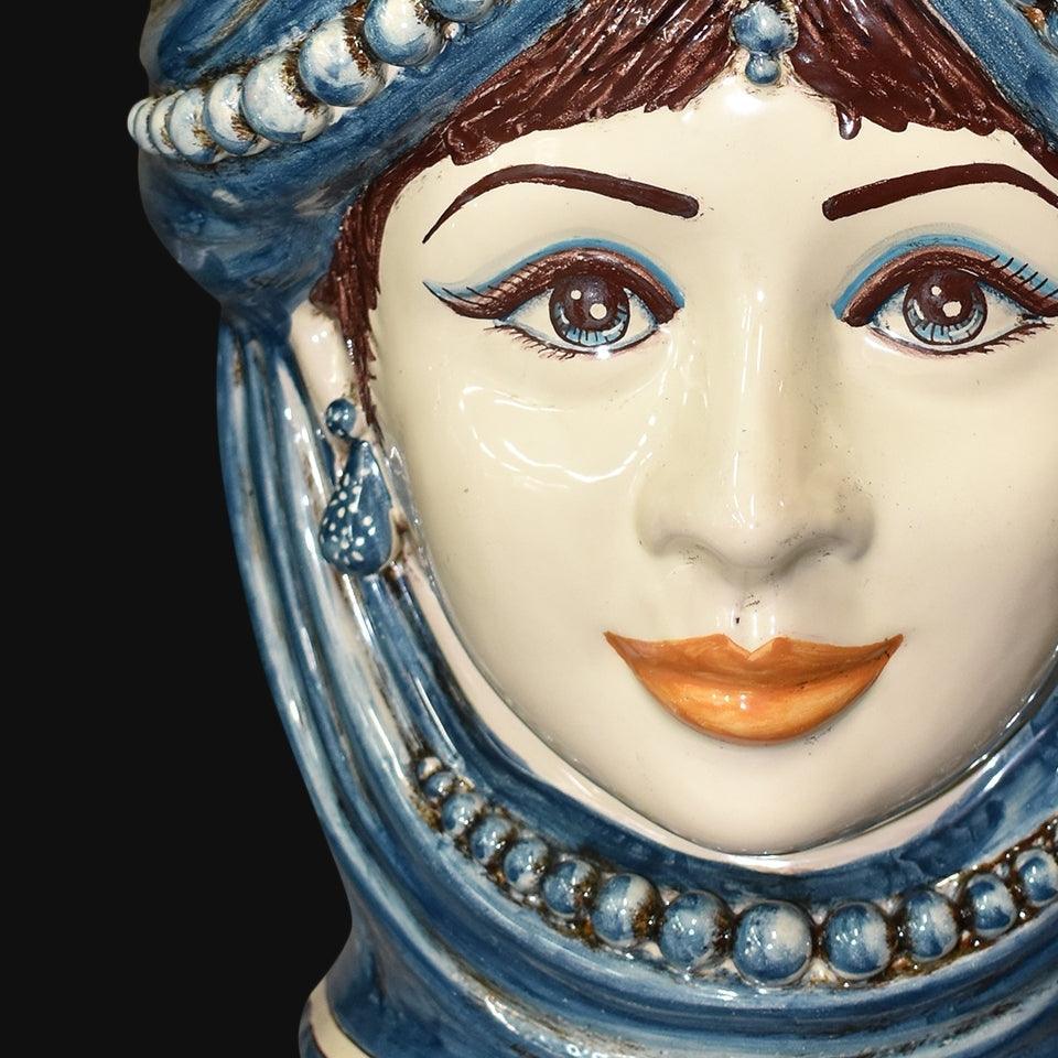 Handmade ceramic Testa di Moro with blue turban, detailed eyes, and ornate beads, blending tradition and modern design.