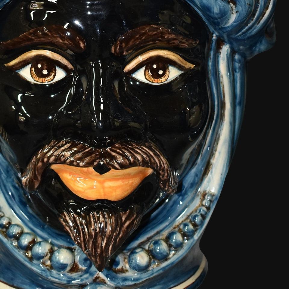 Handmade Teste di Moro ceramic face with blue turban, expressive eyes, and detailed beard, blending tradition and modern design.