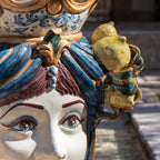 Handcrafted Teste di Moro ceramic with vibrant blue hair, detailed eyes, and lemon accents, blending tradition and modern design.