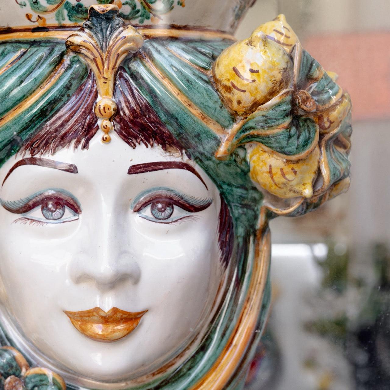 Handcrafted Teste di Moro ceramic vase with vibrant green hair, lemon accents, and detailed facial features