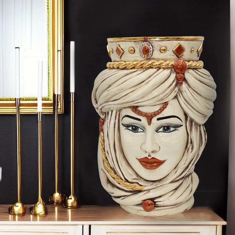Handmade Teste di Moro ceramic vase with ornate turban, gold accents, and gem details, styled on a console table.
