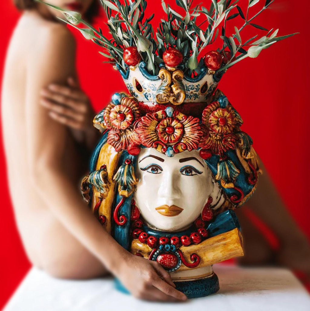 Handcrafted Teste di Moro vase with floral crown, vibrant colors, and olive branches, blending tradition and modern design.