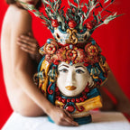 Handcrafted Teste di Moro vase with floral crown, vibrant colors, and olive branches, blending tradition and modern design.