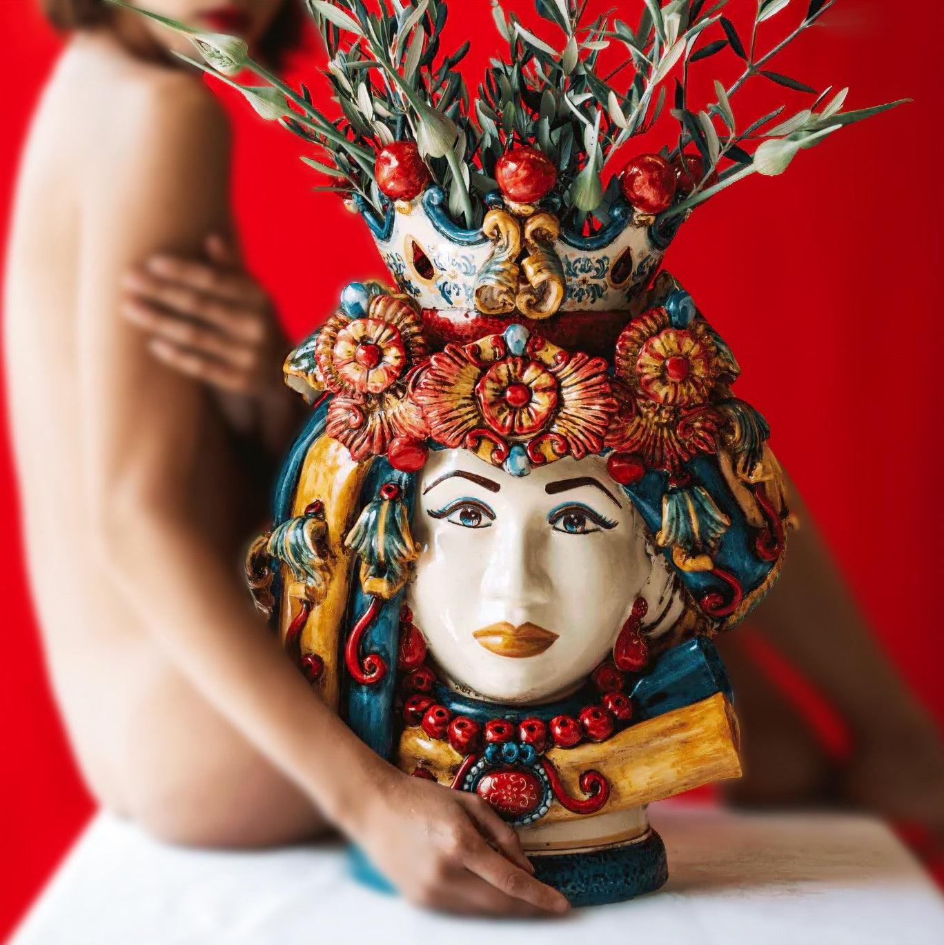 Handcrafted Teste di Moro vase with floral crown, vibrant colors, and olive branches, blending tradition and modern design.