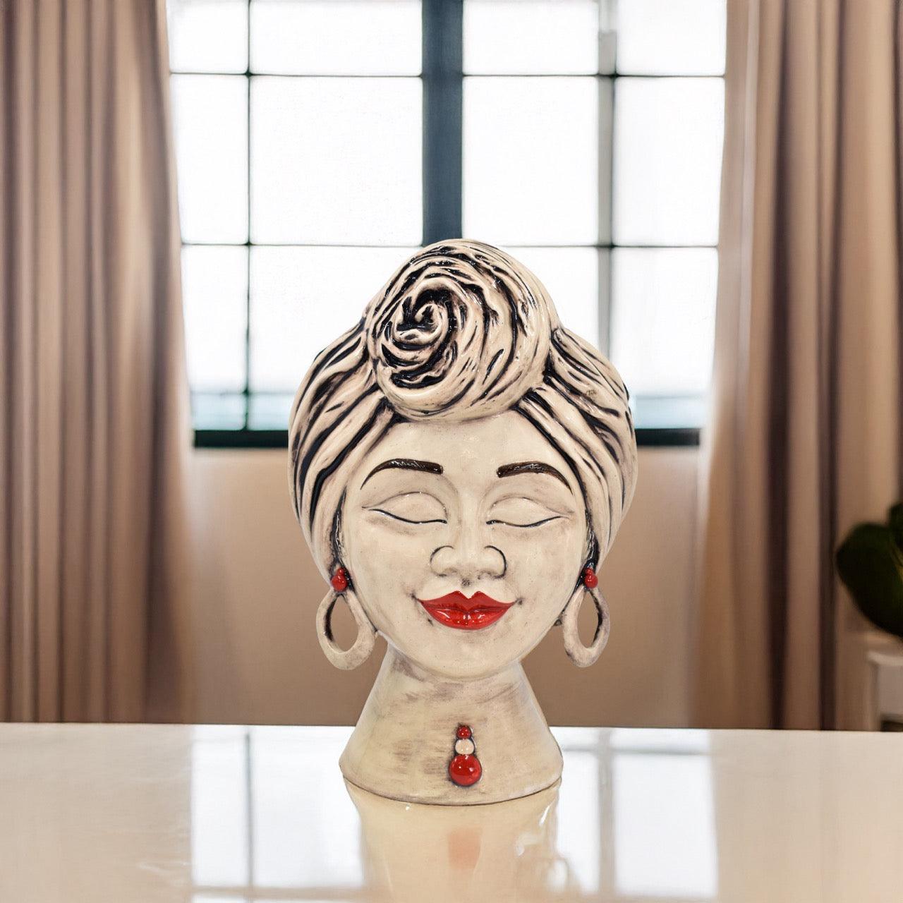 Handcrafted Teste di Moro ceramic bust with red lips, earrings, and rose turban, blending tradition and modern design.